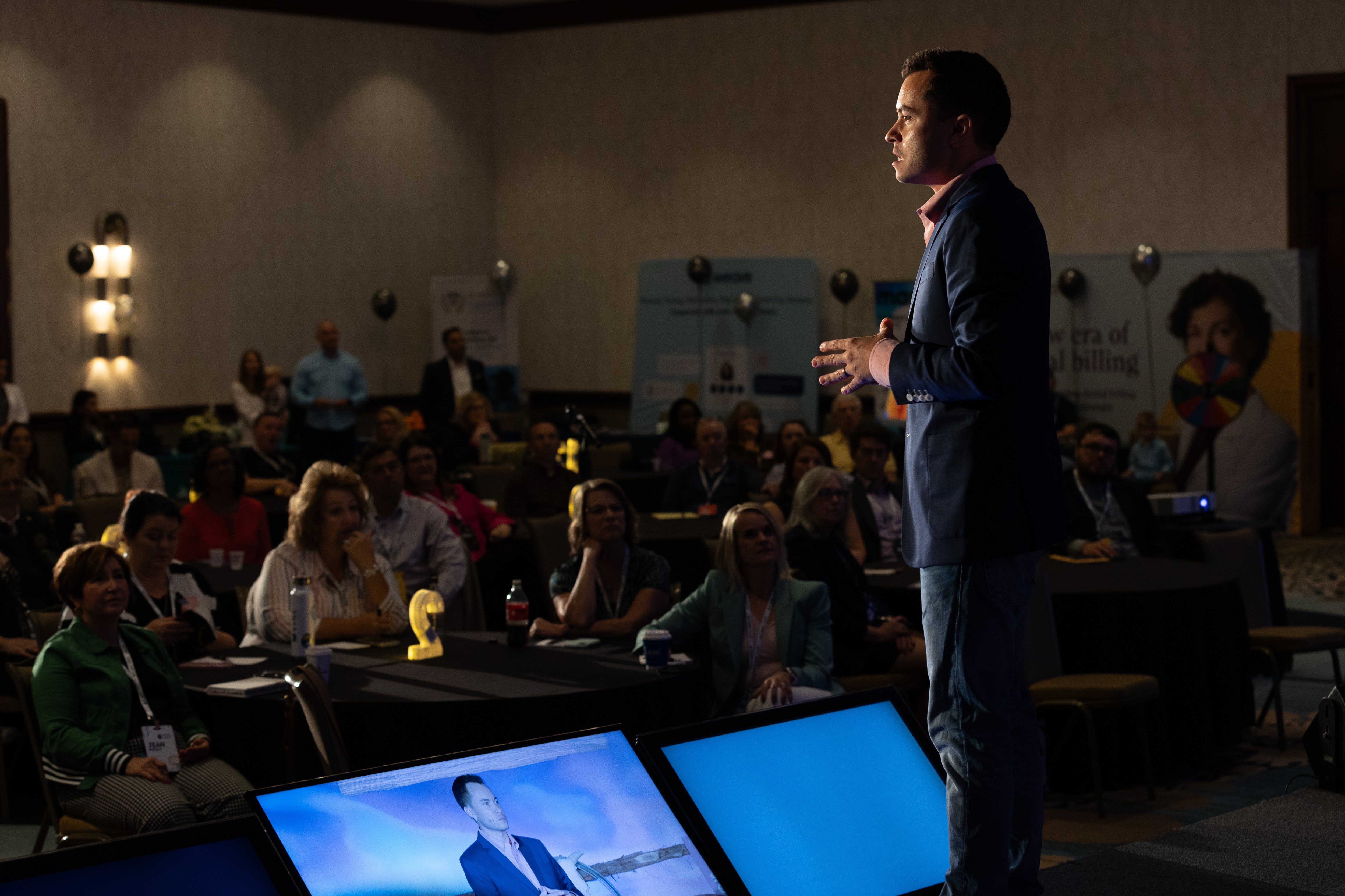 Ryan Vet delivering a keynote to a full conference audience
